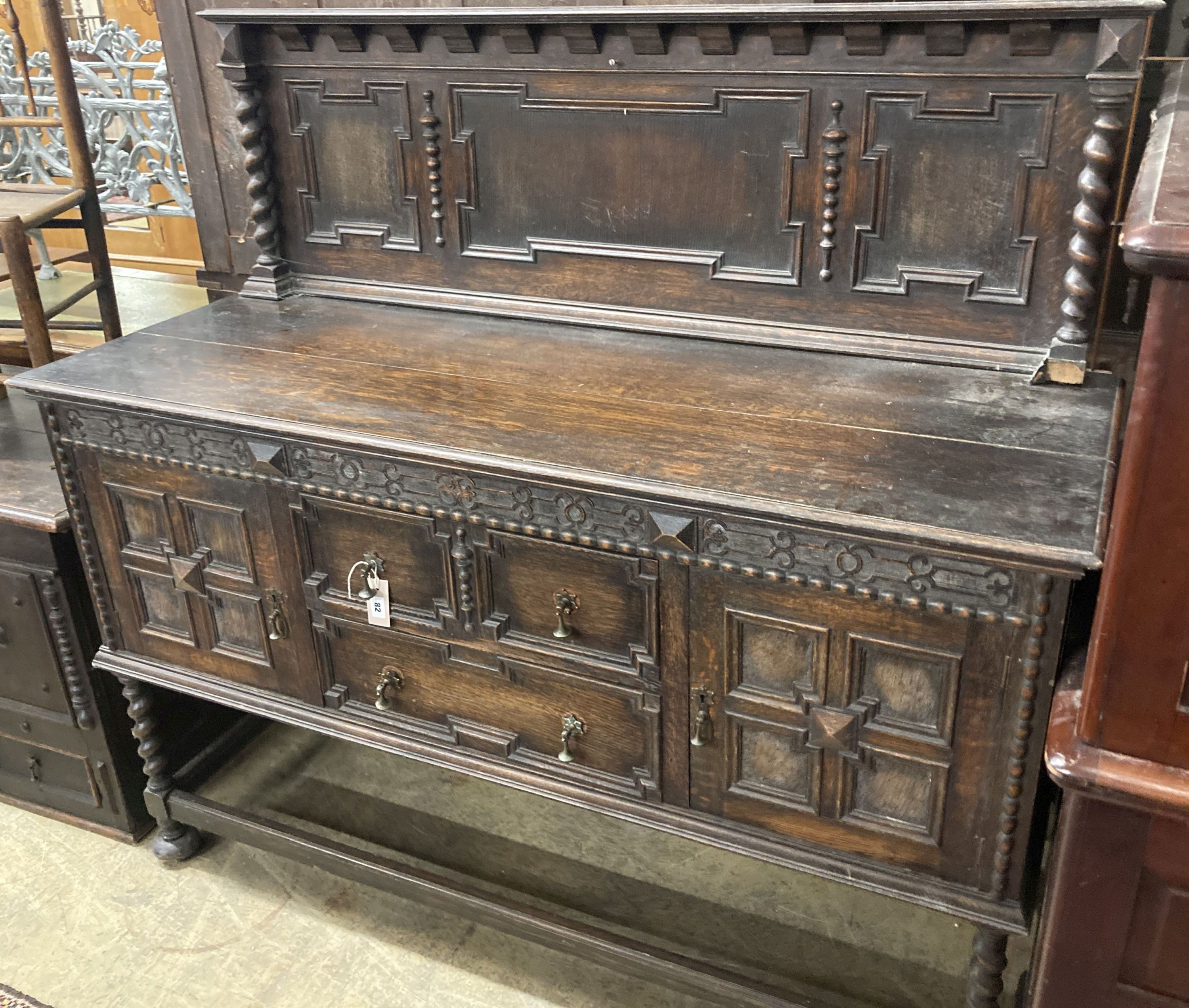 A 1920s Jacobean style oak sideboard, length 152cm, depth 56cm, height 144cm